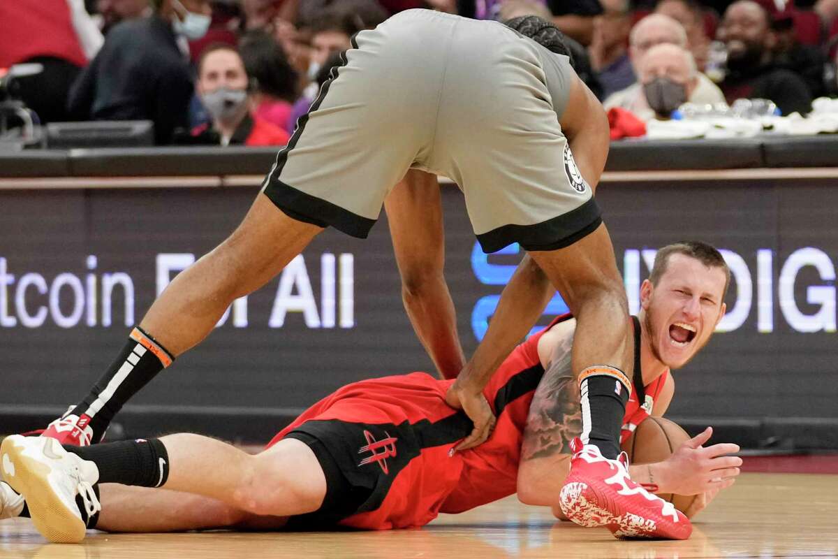 Houston Rockets guard Garrison Mathews, bottom right, reacts after stealing the ball from Brooklyn Nets guard James Harden, top, during the second half of an NBA basketball game, Wednesday, Dec. 8, 2021, in Houston. (AP Photo/Eric Christian Smith)