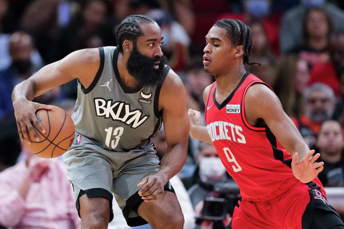 James Harden #13 of the Brooklyn Nets controls the ball ahead of Josh Christopher #9 of the Houston Rockets during the first half at Toyota Center on December 08, 2021 in Houston, Texas.