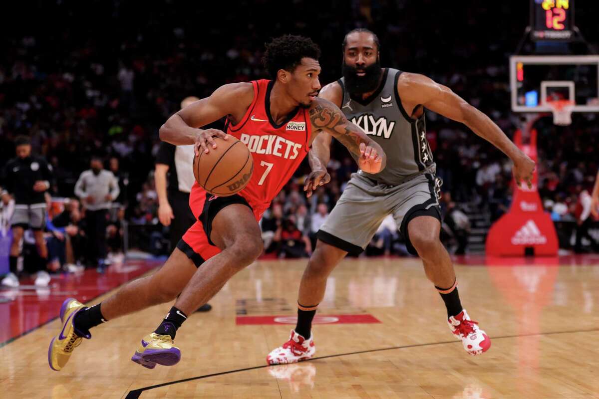 Armoni Brooks #7 of the Houston Rockets drives to the net against James Harden #13 of the Brooklyn Nets during the first half at Toyota Center on December 08, 2021 in Houston, Texas.
