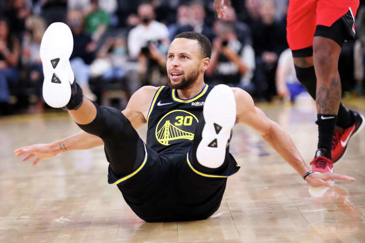 Golden State Warriors' Stephen Curry falls down after missing a 3-pointer in 2nd quarter against Portland Trail Blazers during NBA game at Chase Center in San Francisco, Calif., on Wednesday, December 8, 2021.