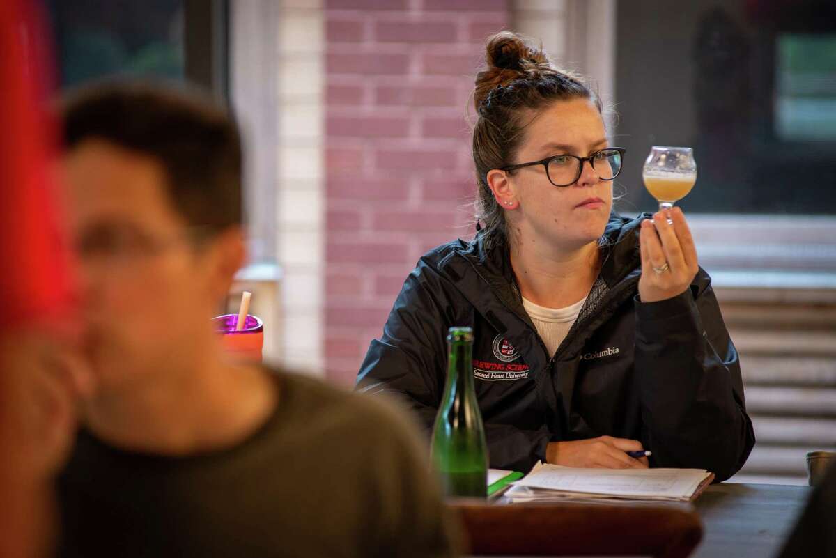 Tess Canning, a Hamden resident and one of Sacred Heart University’s brewing certificate students, conducts a tasting of the beer they made at Two Roads Brewing Area 2. Photo by Tracy Deer-Mirek 8/4/21