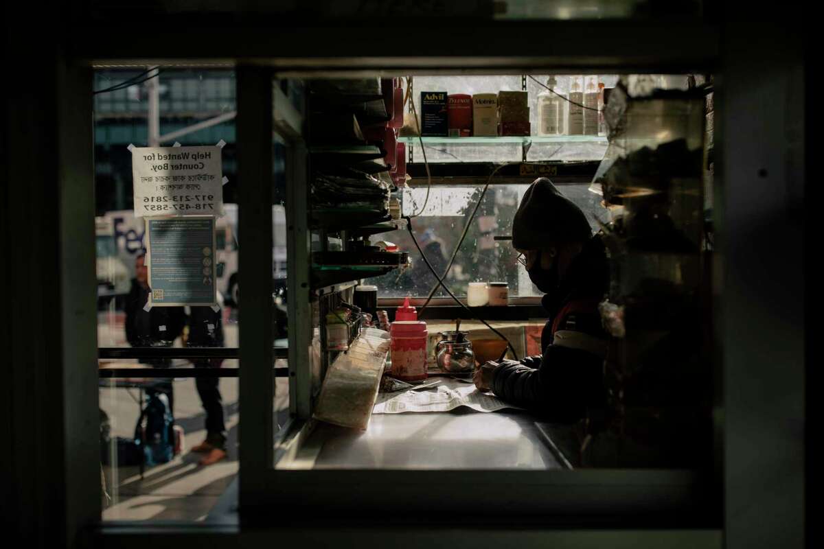 A shopkeeper waits for customers at Diversity Plaza in the Jackson Heights neighborhood of Queens.