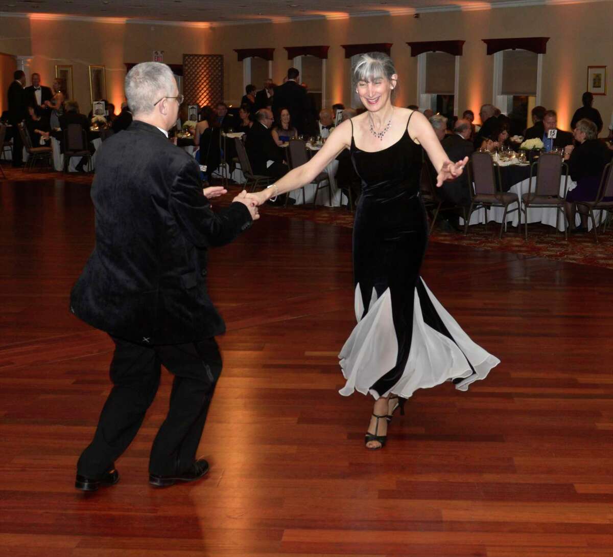 Wallingford resident Stacey Frielle and Hamden resident Louis Mongillo walk around the dance floor at Hat City Ball 2015.