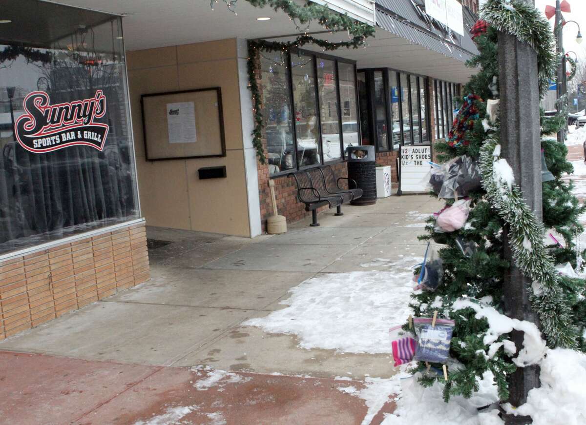 Located in front of Sunny's Bar and Grill in downtown Reed City, this Christmas giving tree has been a place for locals to both give and receive much-needed gifts, such as hats and coats.