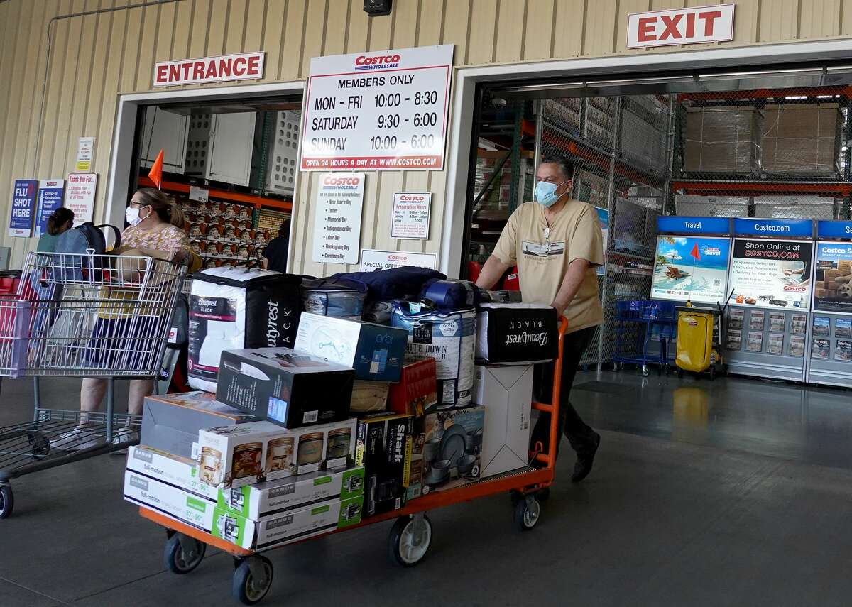 FILE: Consumers exit after shopping in a Costco store on September 28, 2021 in Miami.
