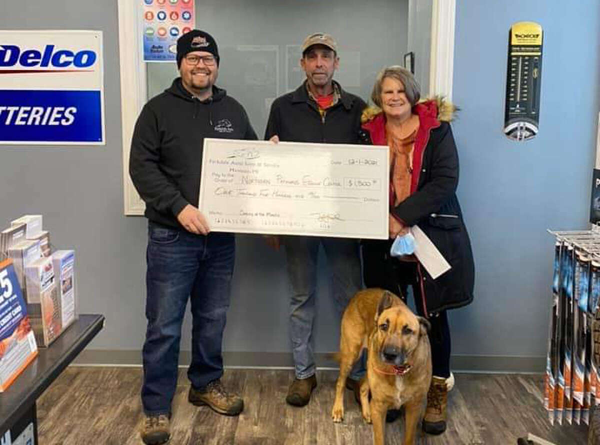 Tyler Reed, of Parkdale Auto Sales & Service, presents check to Mary Van Dorp and Jeff Wagar, of Northern Pathways Equine Center.