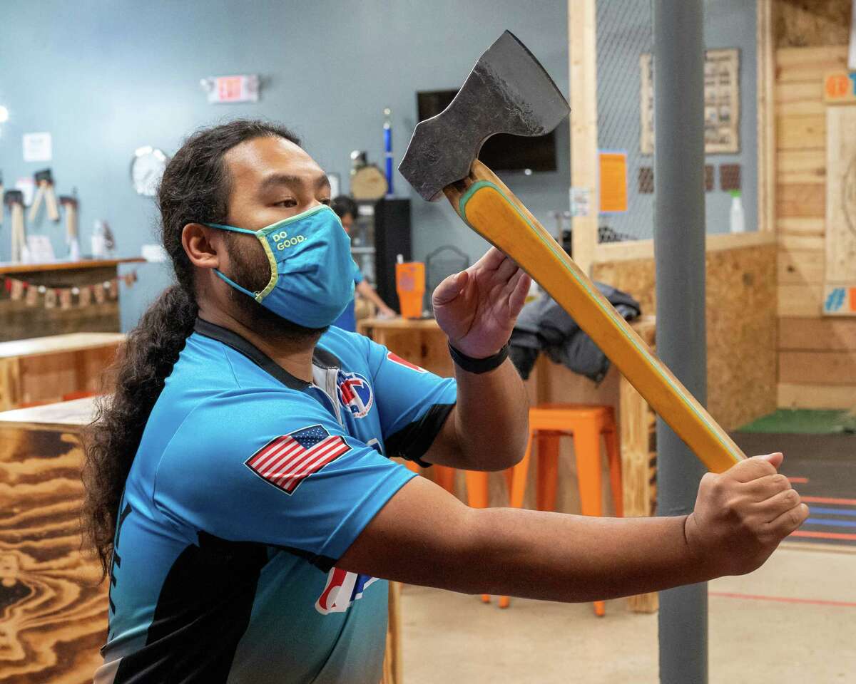 Mark Mirasol practices for the axe-throwing world championship at The Lazy Axe in Colonie on Monday, Dec. 6, 2021. Mirasol took home the big axe title.