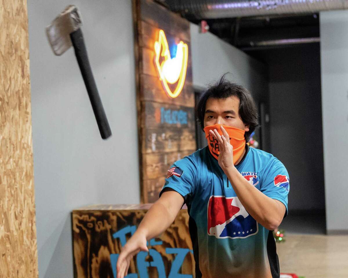 Richard Lin practices for the ax throwing world championship at The Lazy Axe in Colonie, NY, on Monday, Dec. 6, 2021. Lin qualified for duals with throwing partner Jess Renner, who hails from Columbus, Ohio.