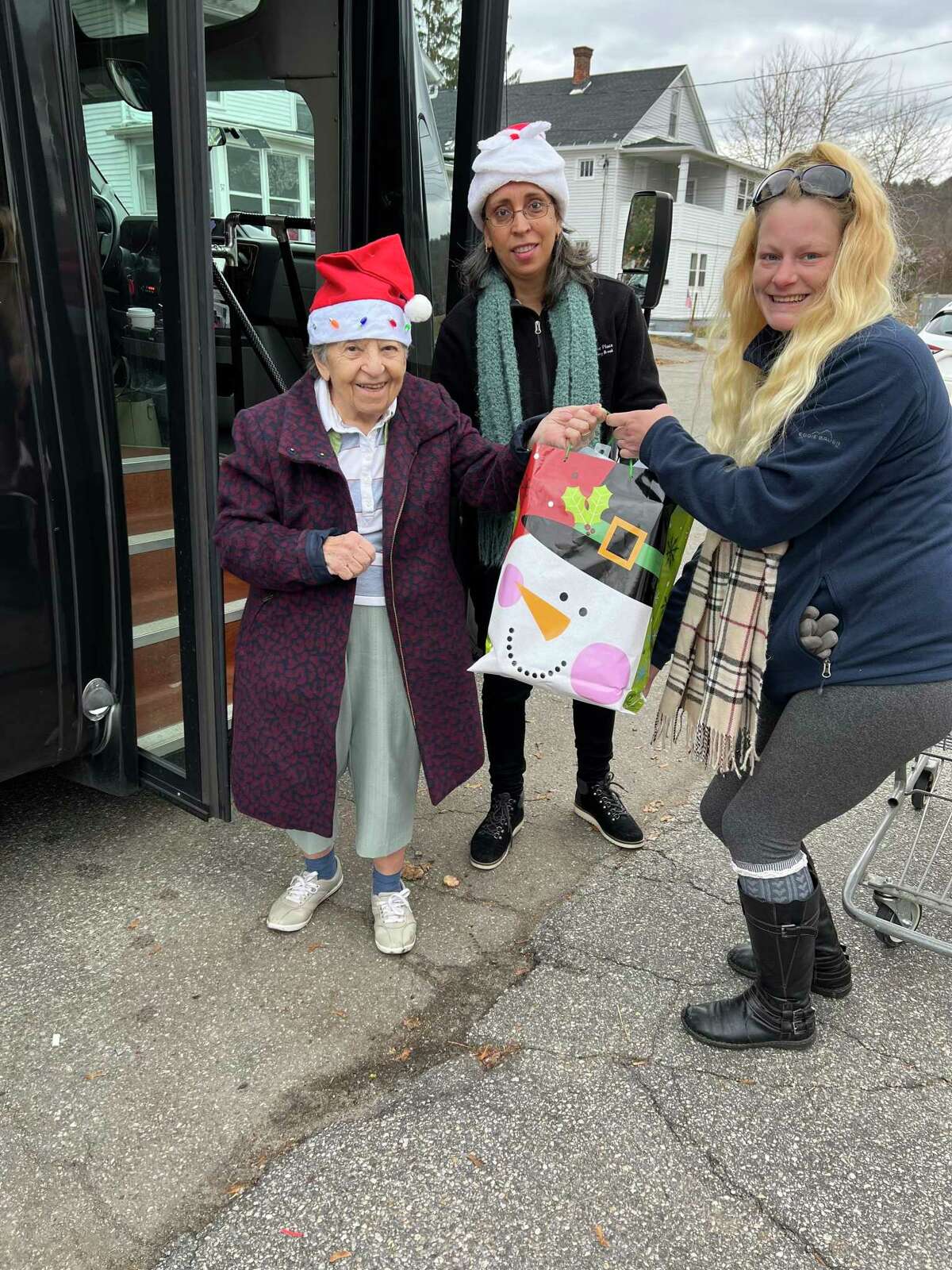 Keystone Place at Newbury Brook in Torrington, a retirement community, hosted two families from Friendly Hands Food Bank, filling their Christmas wish lists. The residents of Keystone place also donated gift certificates and coats to the food bank. On Dec. 8, Keystone delivered the gifts to the food bank in their van. Pictured from left are Keystone resident Lucy Fenn, employee Nelvis Santiago, and food bank staff member Tasha Danboise.