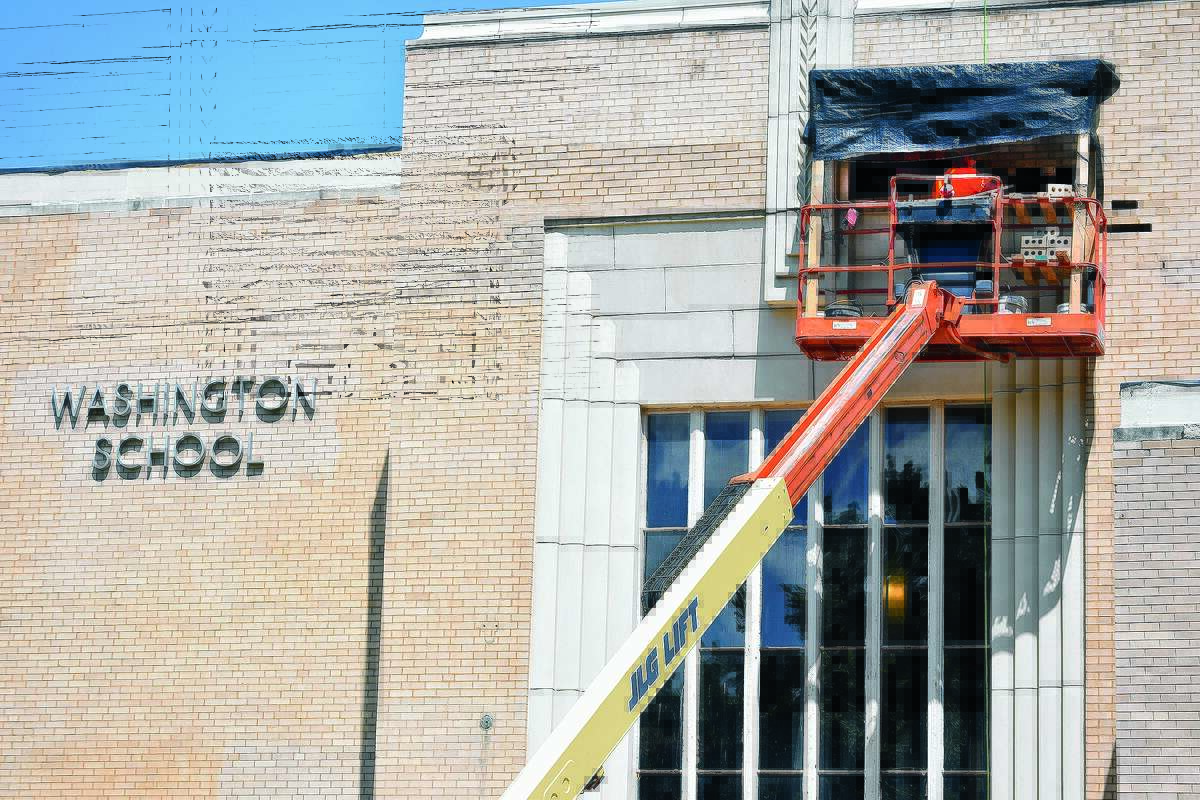Workers fix bricks outside Washington Elementary School in the summer of 2019. 