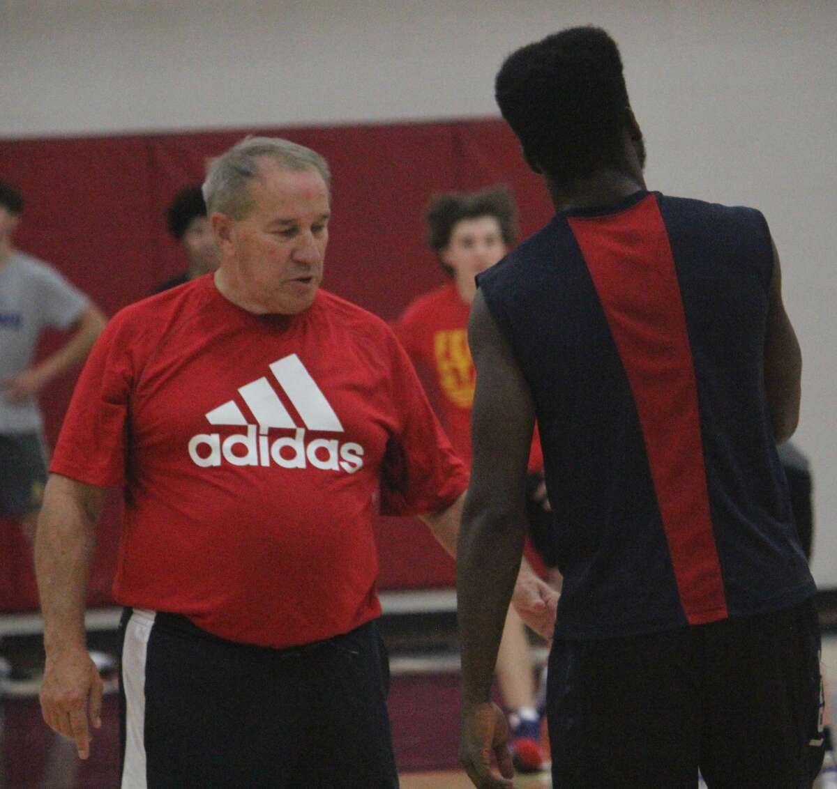 Big Rapids basketball coach Kent Ingles (left) talks to Jamal Strickland after recent practice.