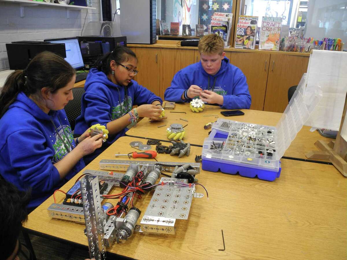 Members of the Wilton Library’s Robotics Team, Singularity Technology, previously work on the robot’s they made wheels at the Wilton Library's Innovation Station in a recent year. Pictured from left to the right are: Shayna Wilson-Spiro, Aarushi Agrawal, and Christopher McCann. One of the upcoming happenings with the Wilton Library is a “Destroy Your Hard Drive,” robotics team fundraiser event on Saturday, Dec. 11, from 10 a.m. to 2 p.m.