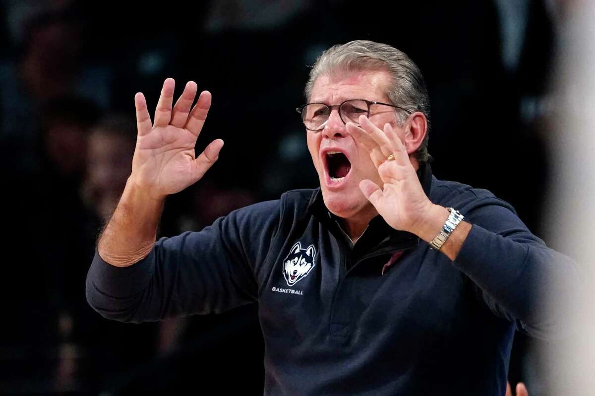 Connecticut coach Geno Auriemma yells to players on the floor during the first half of the team's NCAA college basketball game against Georgia Tech on Thursday, Dec. 9, 2021, in Atlanta. (AP Photo/John Bazemore)