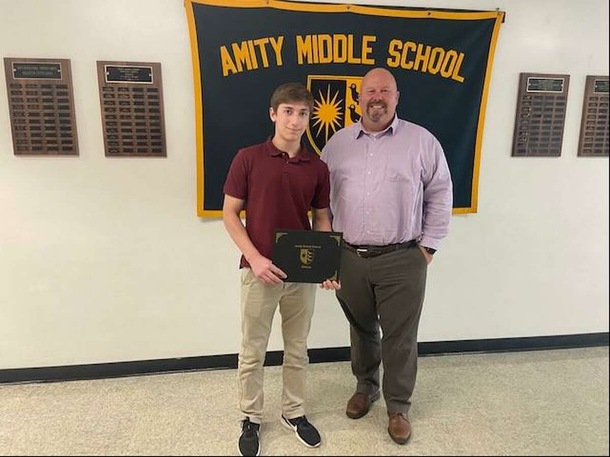Principal Dr. Jason Tracy, left, and the Amity Middle School Bethany community recently congratulated eighth-grade students Kirby Perler, pictured, and Sophia Messina, who were selected by the school to receive the 2020-21 Scholar-Leaders Award sponsored by the Connecticut Association of Schools. This award program is designed to recognize two students from each middle level school in Connecticut, who have distinguished herself/himself in scholarship and leadership in school and community.