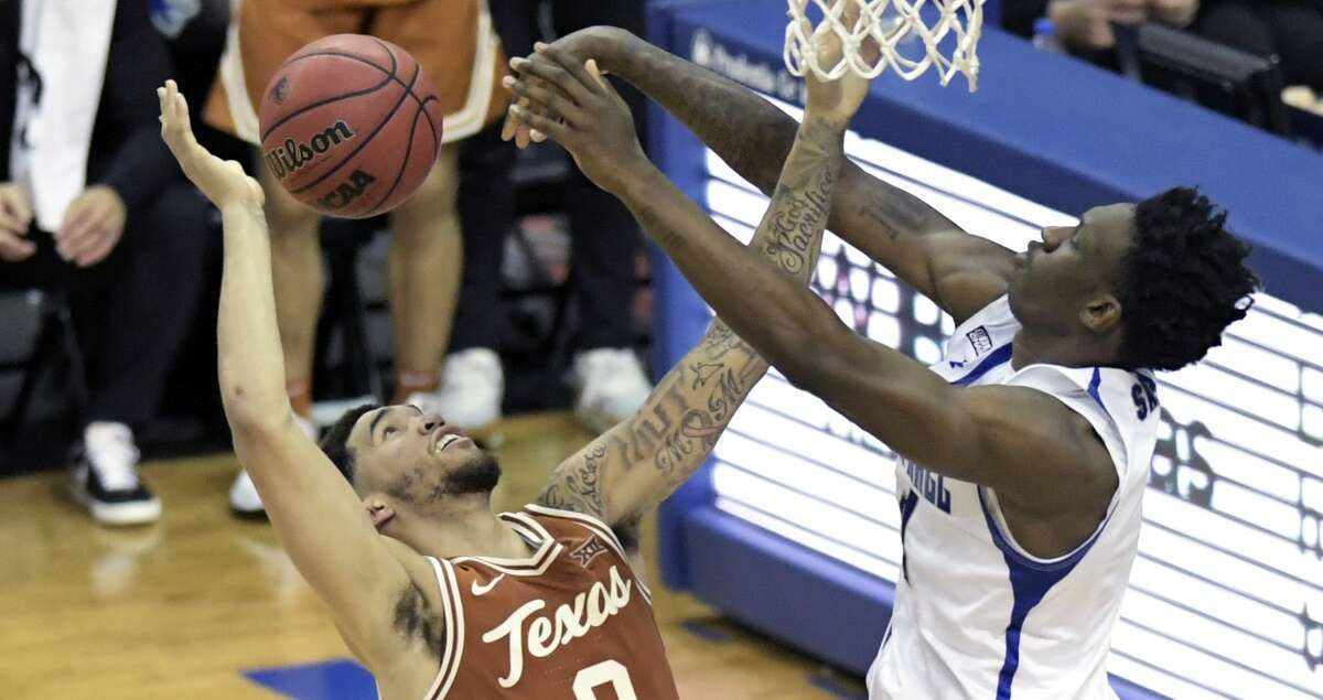 Seton Hall forward Tyrese Samuel (4) blocks a shot by Texas forward Timmy Allen (0) during the second half of an NCAA college basketball game Thursday, Dec. 9, 2021, in Newark, N.J. (AP Photo/Bill Kostroun)