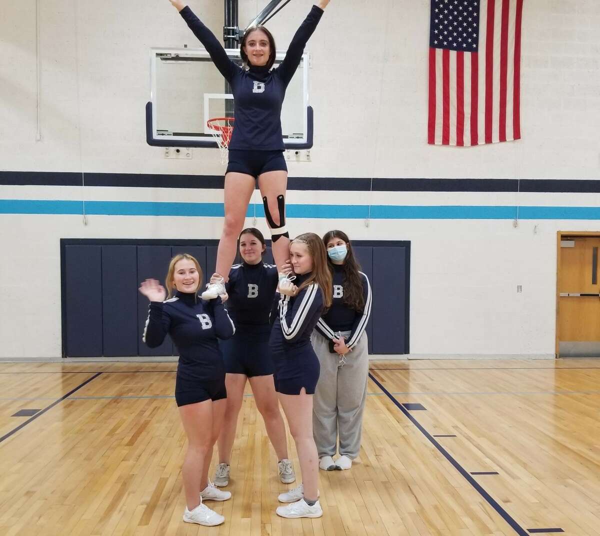 The Brethren competitive cheer team performs a pyramid in practice.