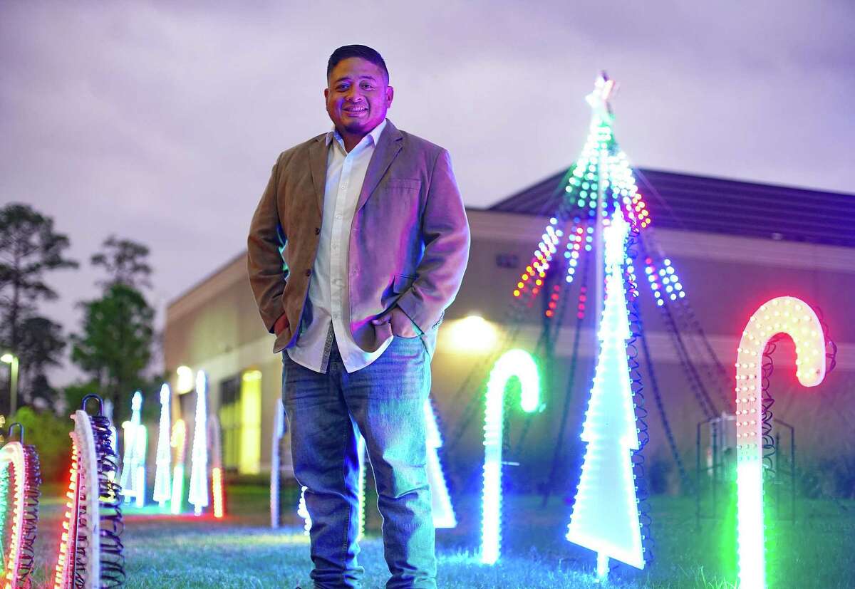 Frankie To-ong stands in front of his special light show for Christmas at Texas Children's in The Woodlands on Tuesday, Dec. 7, 2021. To-ong, whose daughter had heart surgery at the hospital, wanted the children who are patients to not feel like they are missing the holidays.