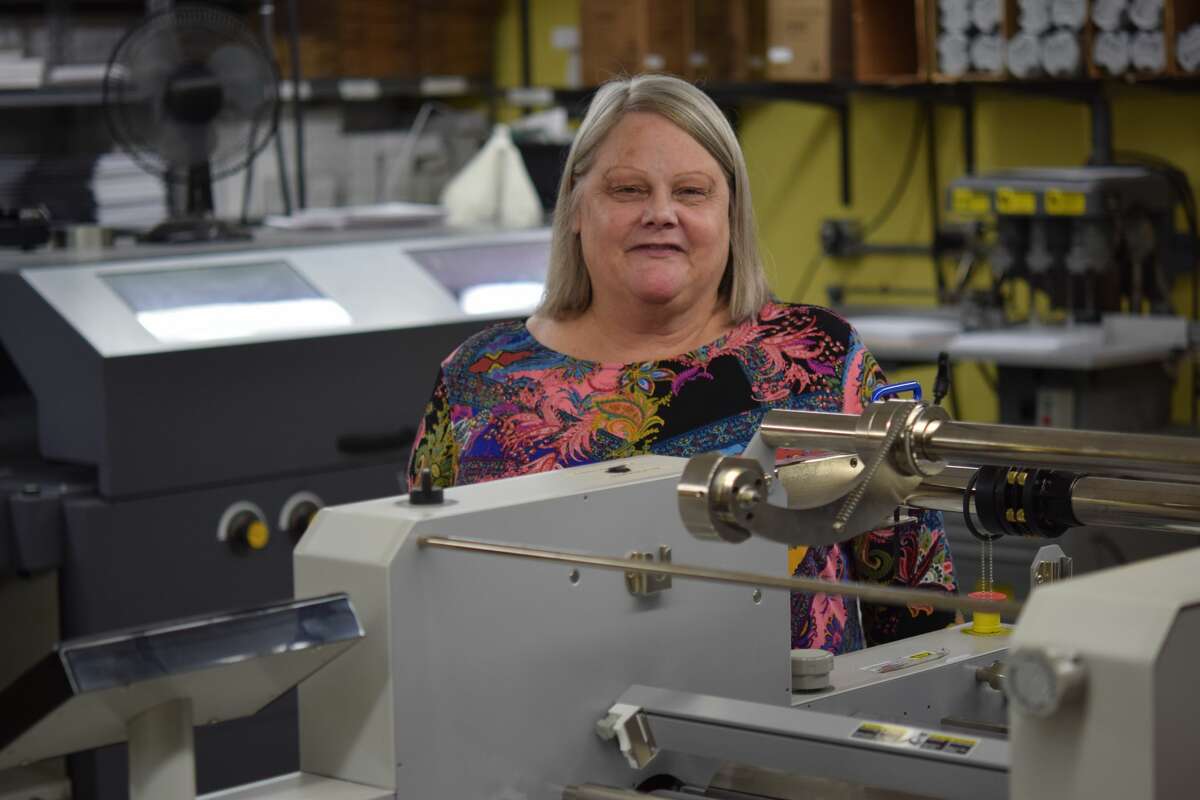 Faith Printing co-owner JaNell Lyle is surrounded by some of the machinery her business uses for printing and publishing.