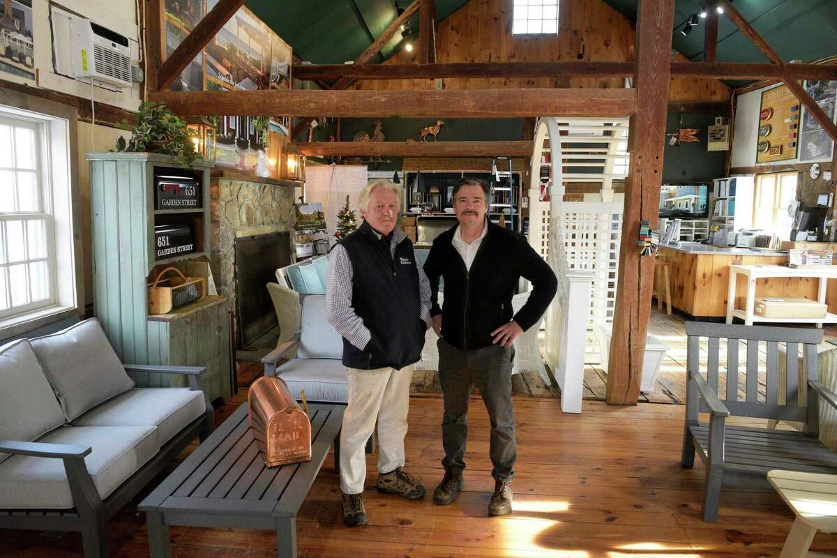 Design consultant Erik Andersen, left, and showroom manager Jeff Gorton, of Walpole Outdoors. The business is consolidating its operations and moving out of Ridgefield after more than 60 years. It deals in outdoor fences, furniture and other products. Thursday, Dec. 9, 2021. Ridgefield, Conn.