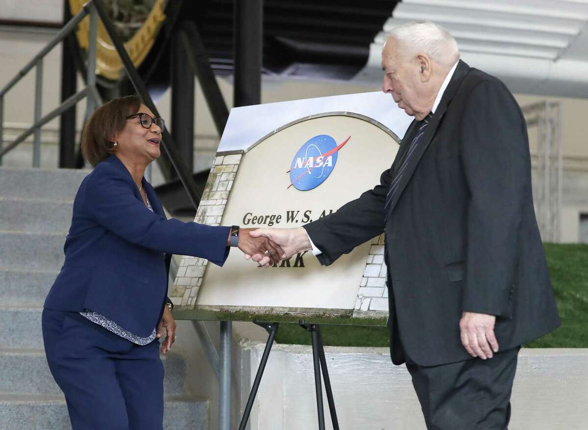 Vanessa Wyche, director of the Johnson Space Center, shakes hands with George W.S. Abbey, a former director of the Johnson Space Center, during a ceremony to rename the Rocket Park at NASA's Johnson Space Center to George W.S. Abbey Rocket Park, Friday, Dec. 10, 2021 in Houston.