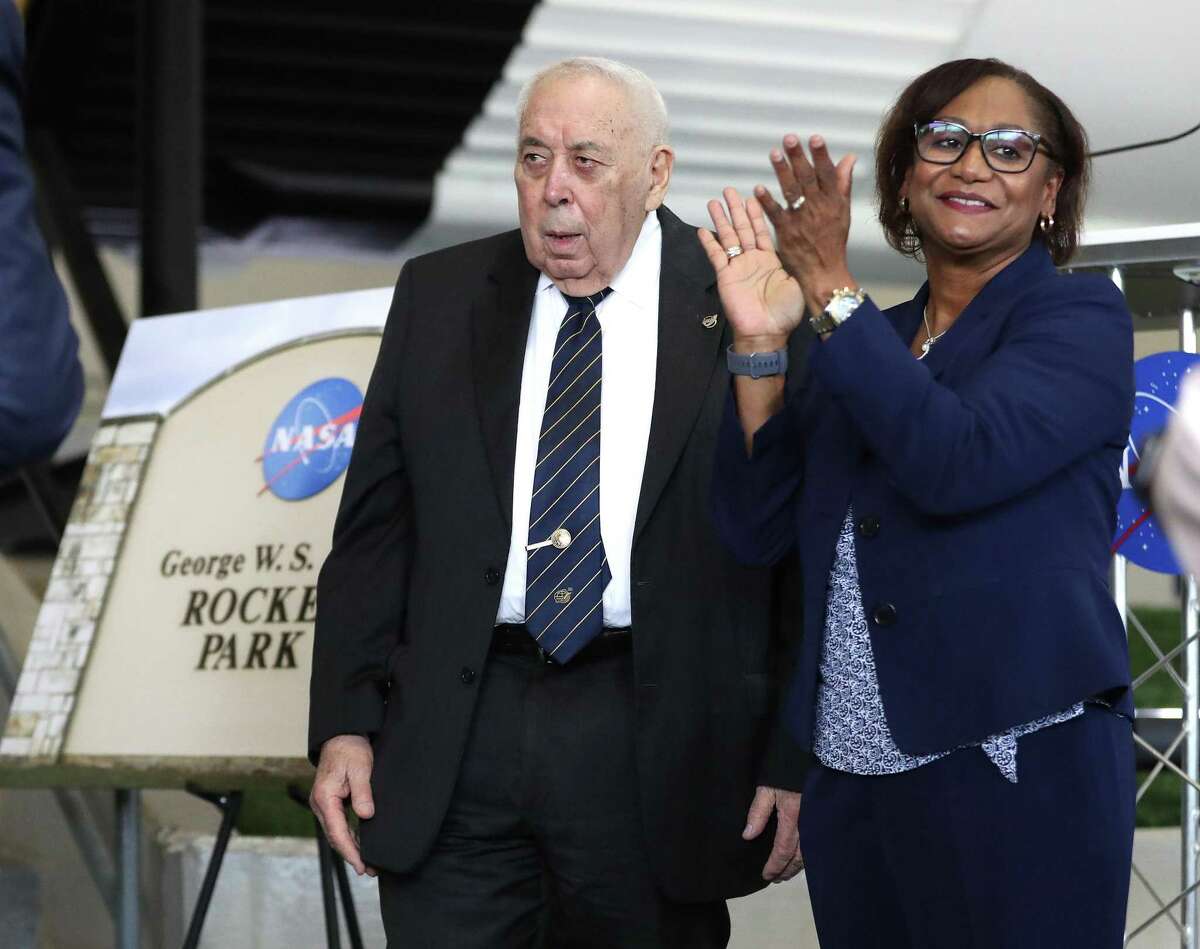 Vanessa Wyche, director of the Johnson Space Center, claps for George W.S. Abbey, a former director of the Johnson Space Center, during a ceremony to rename the Rocket Park at NASA's Johnson Space Center to George W.S. Abbey Rocket Park, Friday, Dec. 10, 2021 in Houston.