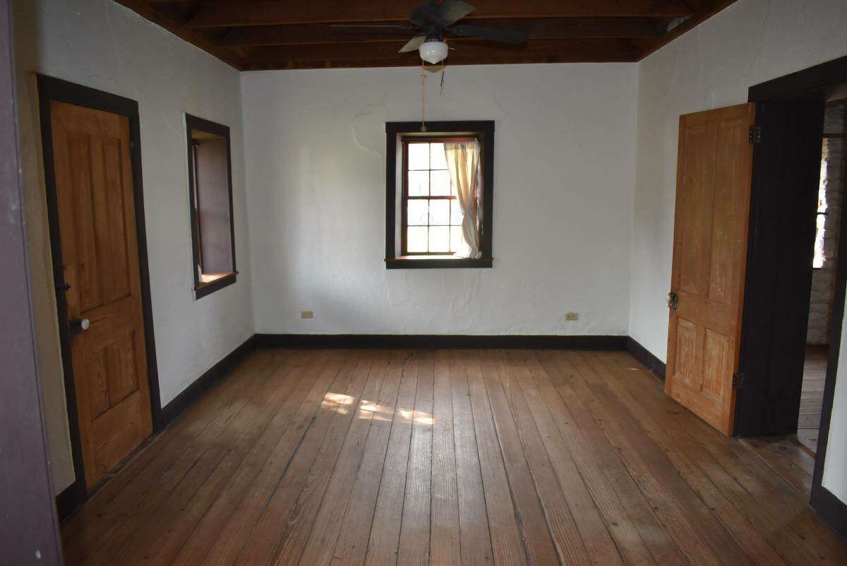 Here is what could possibly be the bedroom, which has a door that opens up into the front of the home.