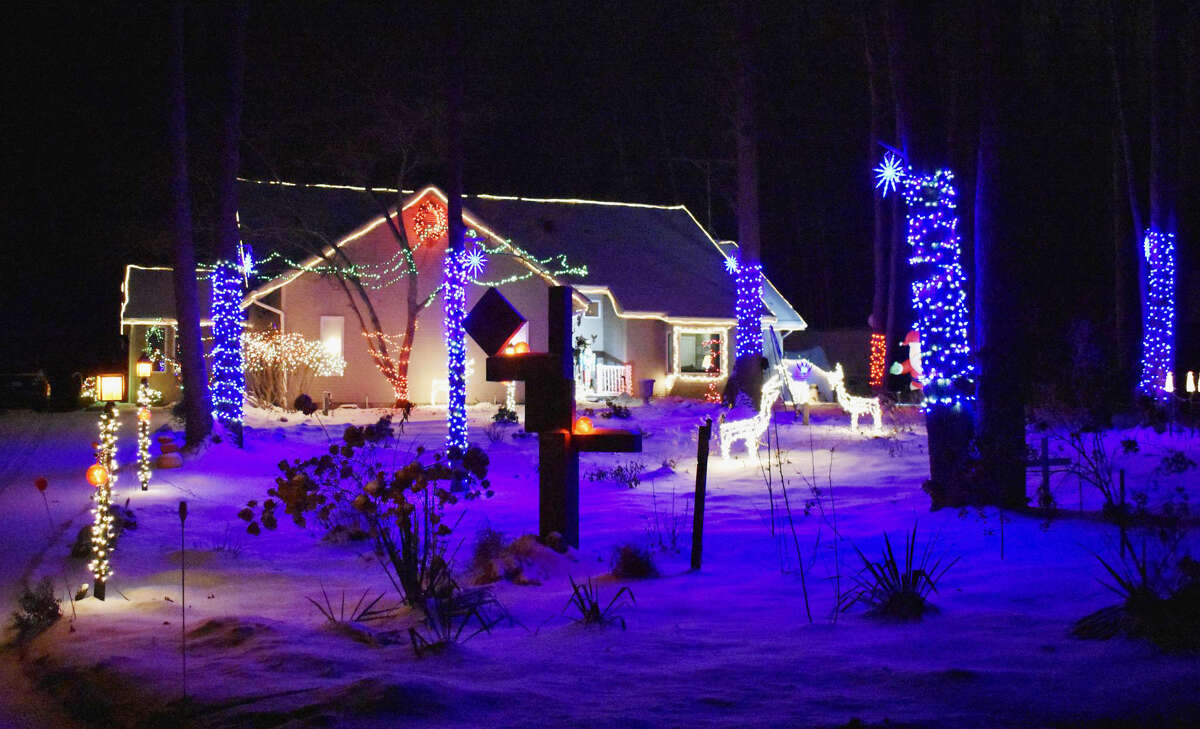 Peter Kent and his family have continued their tradition of creating a bright and colorful lights display for the holiday season that covers their entire house and front and back yard. 
