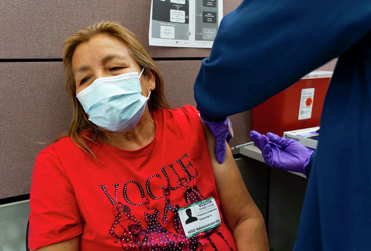 Francisca Zosalla Perez receives a Covid booster dose from RN Ida Griffin at the Houston Health Department’s La Nueva Casa de Amigos Health Center on North Main Street, Friday, Dec. 10, 2021, in Houston.