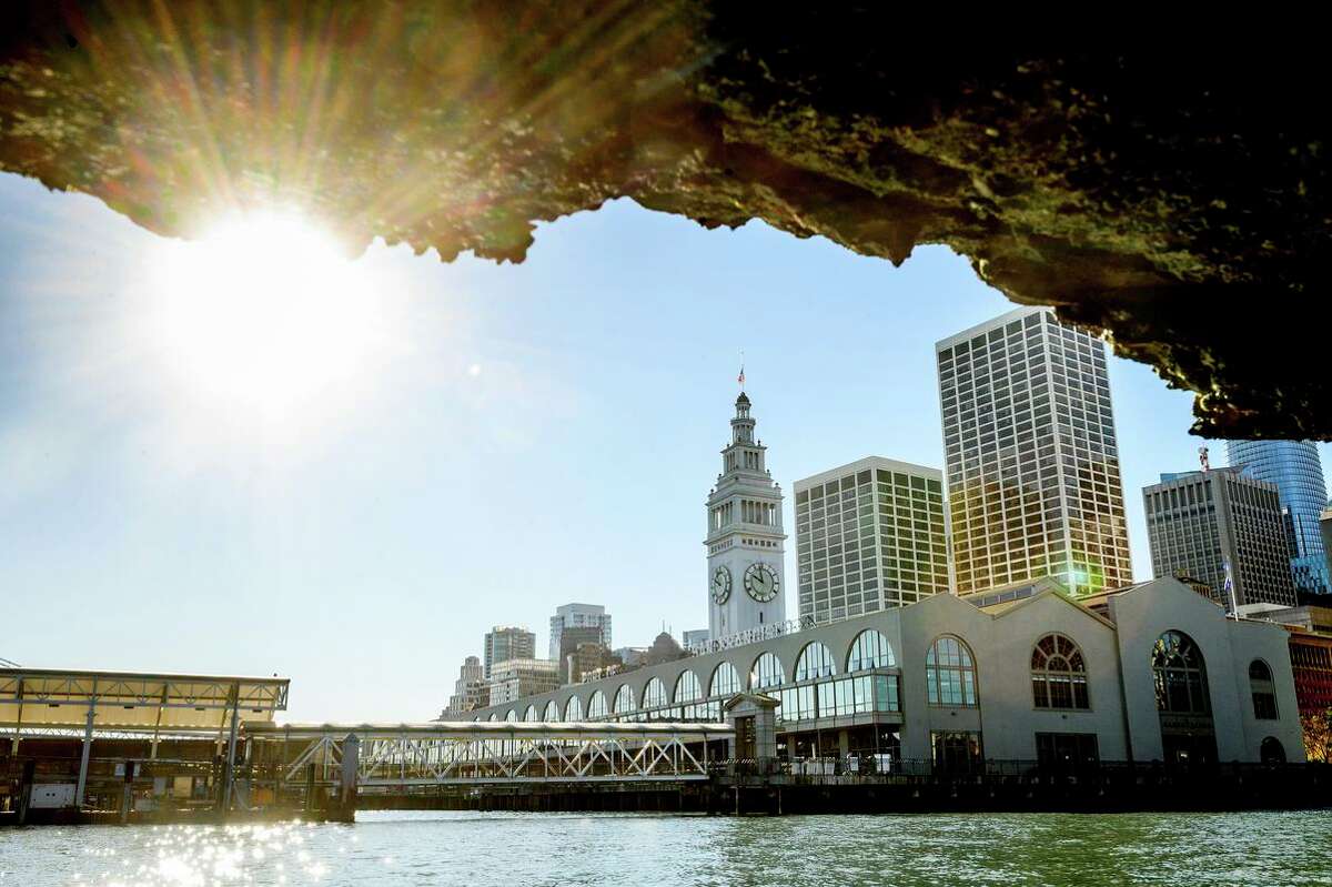 The Ferry Building, pictured through a crumbling section of Pier 1, sits above the Transbay Tube. One proposal would raise the building and install a new seawall.