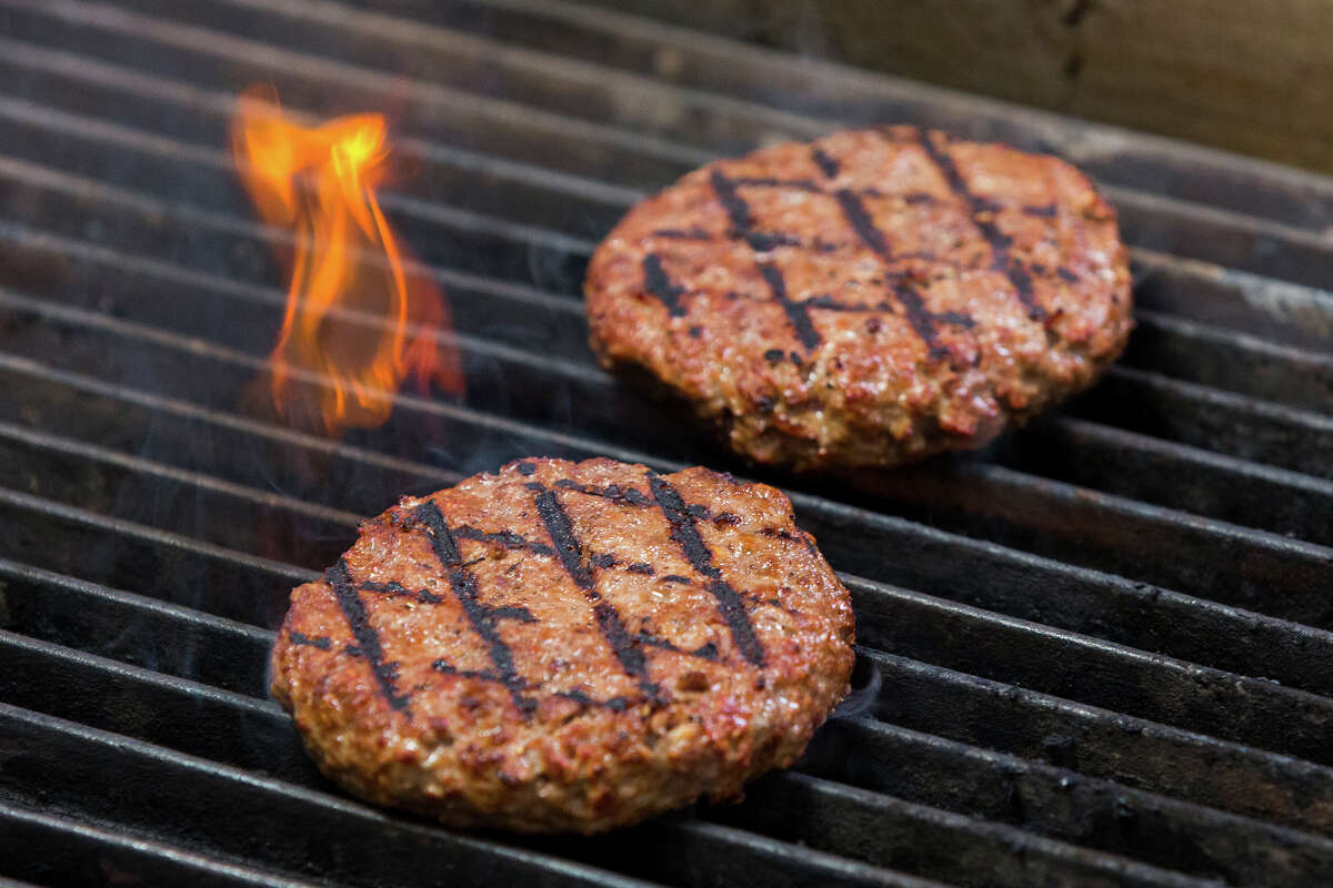Impossible Burger patties on the grill.