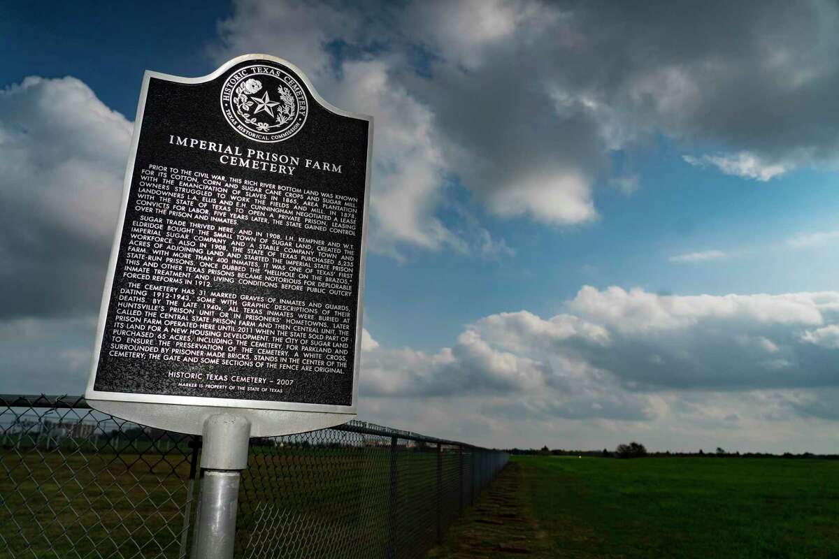 A historical marker denotes the Imperial Prison Farm Cemetery, Thursday, Dec. 9, 2021, in Sugar Land. The existing cemetery is not far from where human remains were found during the construction of Fort Bend ISD’s James Reese Career and Technical Center in 2018. Reginald Moore, who maintained the Imperial Prison Farm Cemetery, made it his mission to implore people that there were more remains of victims of Texas’ convict-leasing program on the land. A new cemetery next to the James Reese Career and Technical Center now marks the remains of the Sugar Land 95. Fort Bend ISD last month approved a contract with MASS Design, an international architecture non-profit, to create a design for an outdoor exhibit to honor the Sugar Land 95.