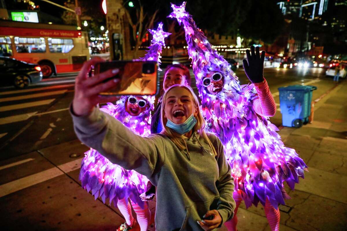 Jenna Lapuyade takes a selfie with David Sweeney (left) and Michael Morris, who spread cheer as the Tree Twins.