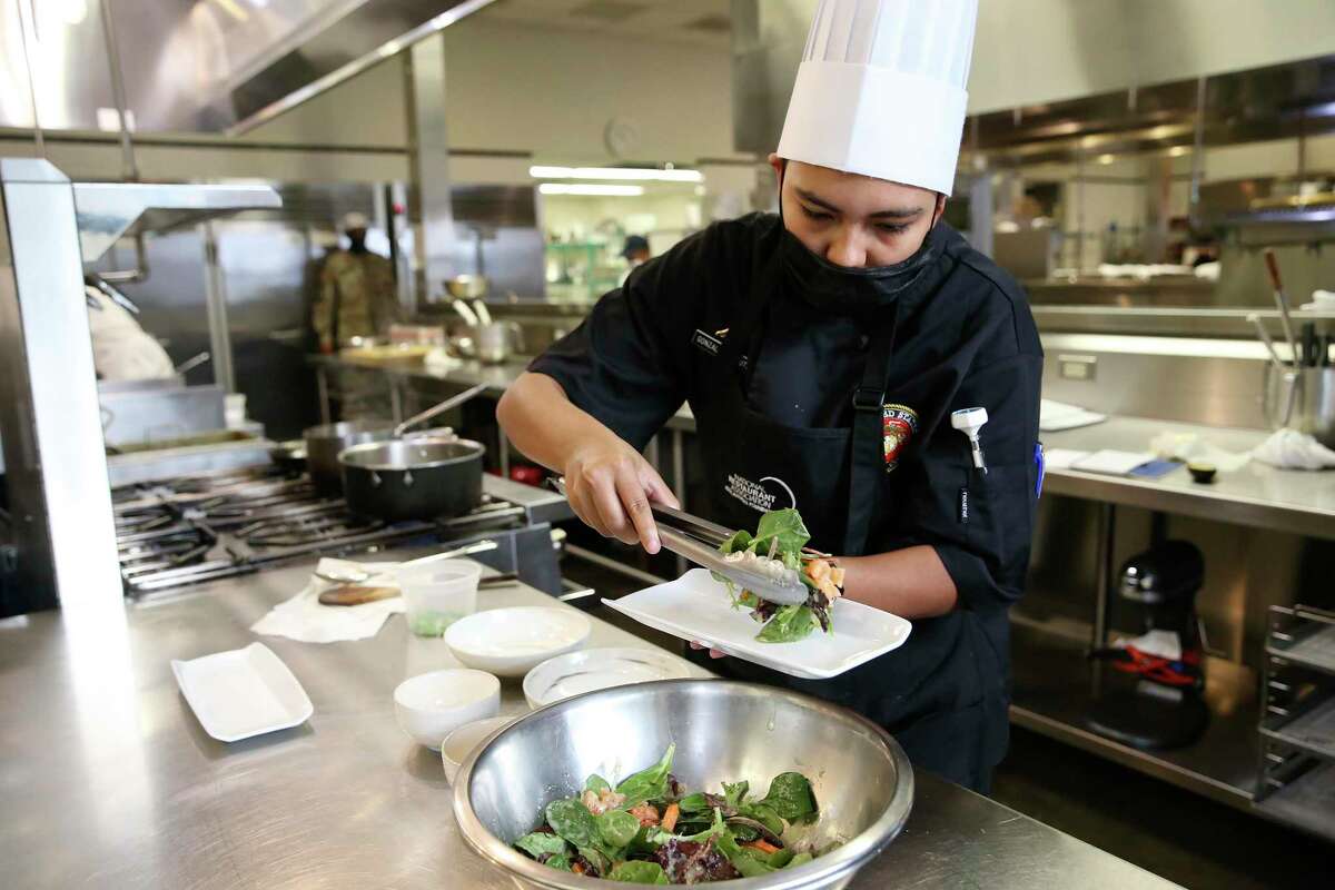 Marine Lance Cpl. Ashley Gonzalez, of Virginia, plates a salad while training at the Culinary Institute of America on Friday.