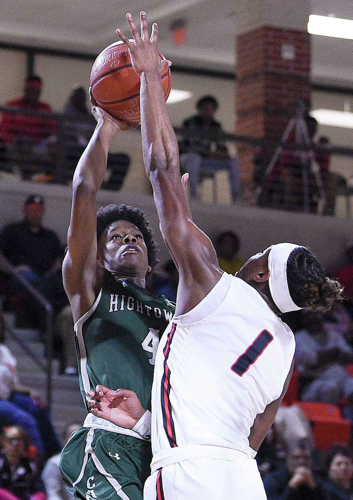 Hightower guard Ja'cory Chatman, left, shoots as Port Arthur Memorial guard Amaree Abram defends during the first half of a high school basketball playoff game, Friday, Feb. 28, 2020, in La Porte, TX.