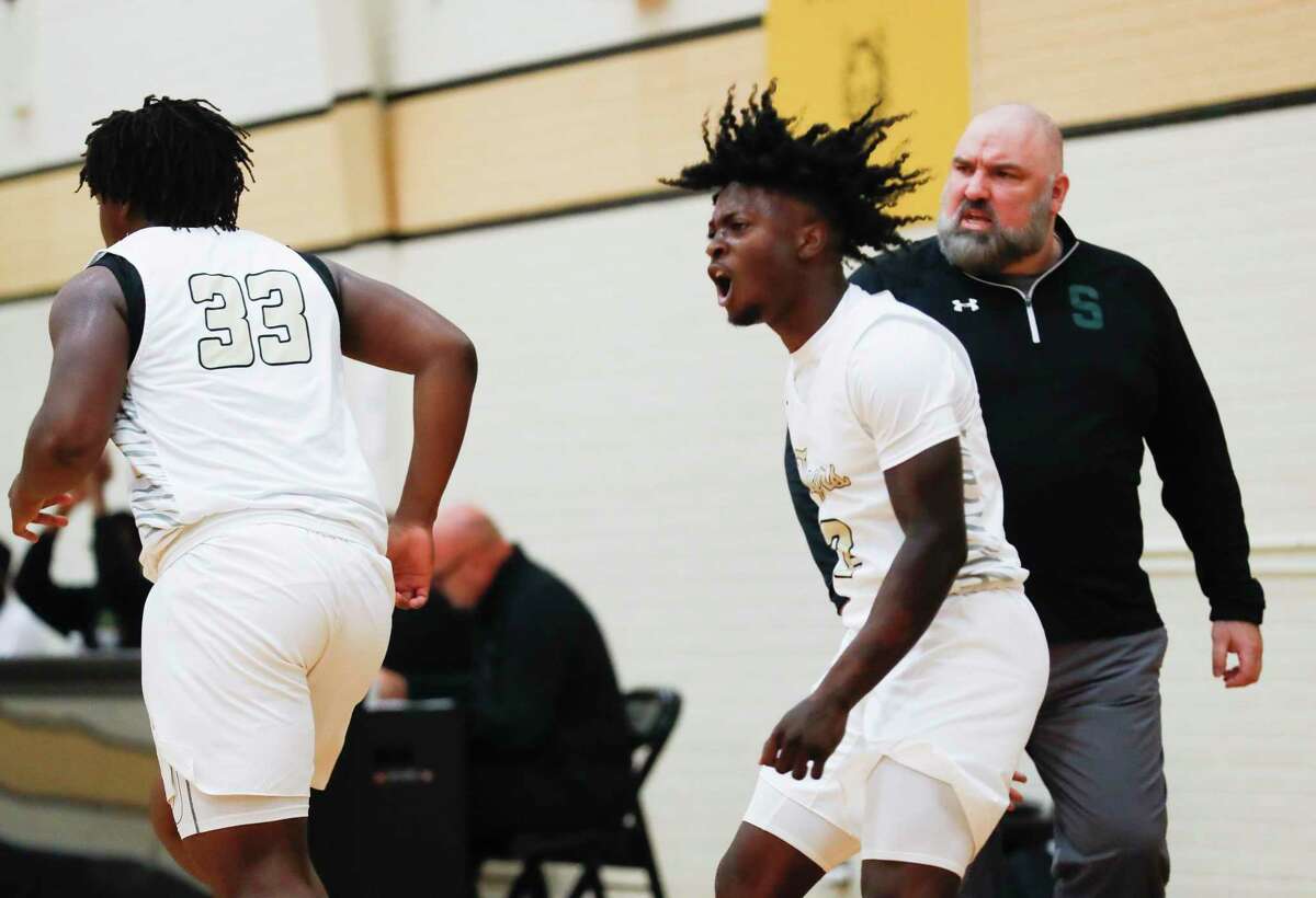 Conroe guard Trashaun Kindle (2) reacts after a three-pointer by forward Kamari Weatherspoon (33) during a game last week.