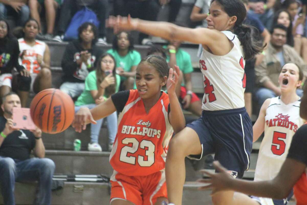 La Porte Junior High's Jordan Gamble (23) hurries to get by Bondy Intermediate's Mia Guerrero  in her attempt to score Friday night. In the background is Patriots player Casey Crawford. (5).
