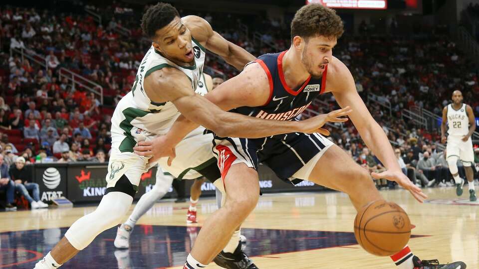 Houston Rockets center Alperen Sengun (28) keeps control of the ball as Milwaukee Bucks forward Giannis Antetokounmpo (34) applies pressure in the second half of game action the Toyota Center on Friday, Dec. 10, 2021 in Houston . Milwaukee Bucks won the game 123-114.