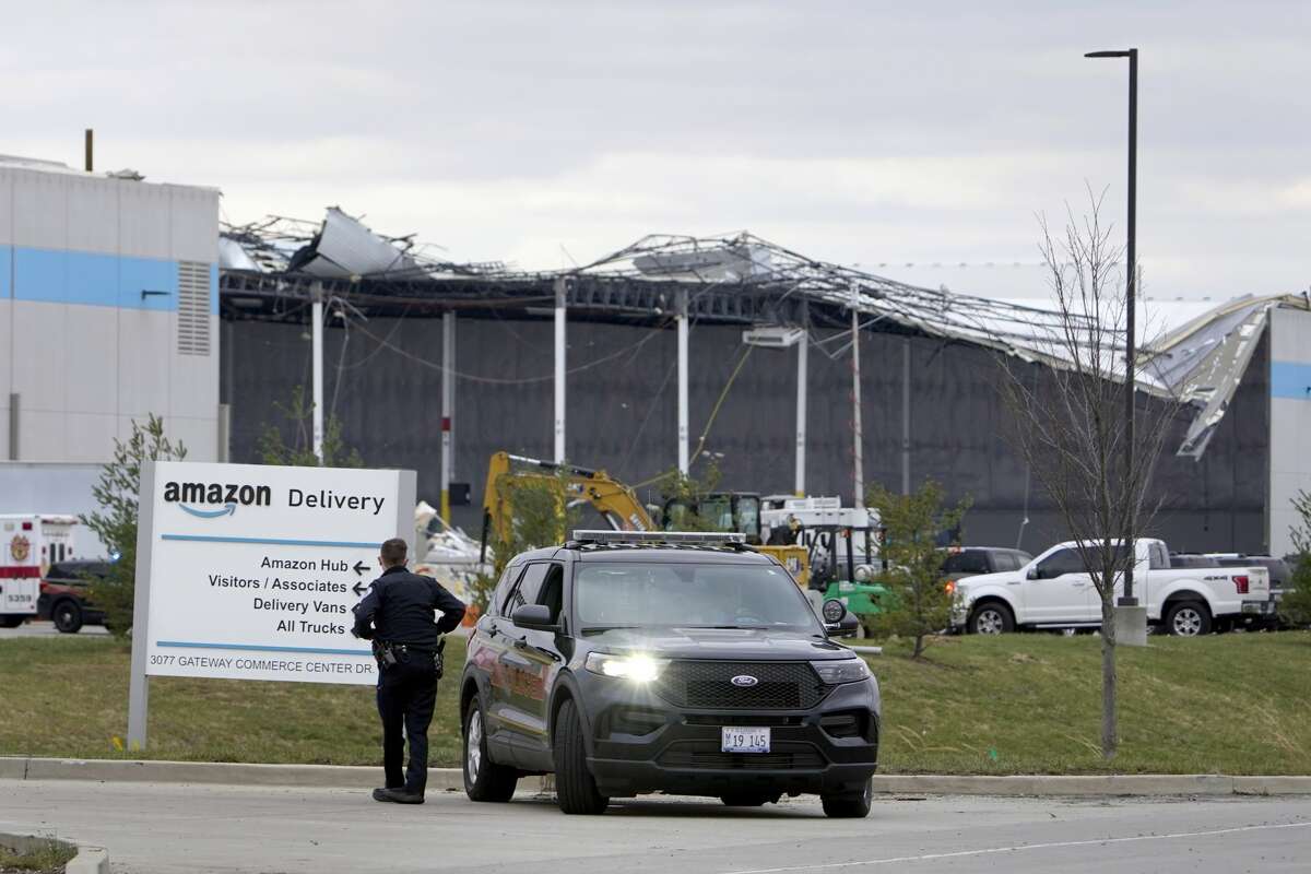 A heavily damaged Amazon fulfillment center is seen Saturday, Dec. 11, 2021, in Edwardsville, Ill. A large section of the roof of the building was ripped off and walls collapsed when strong storms moved through area Friday night. 