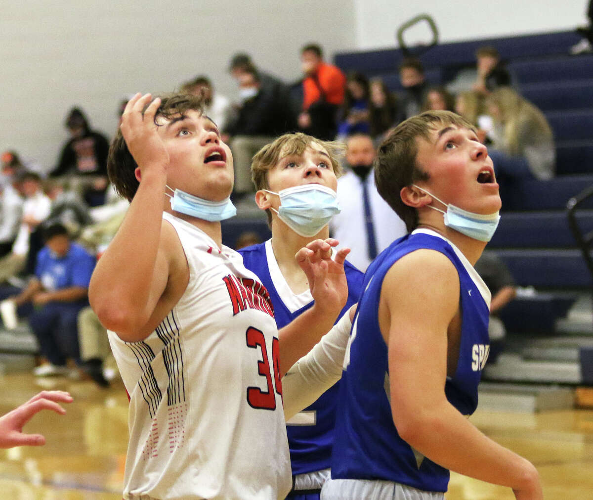 Calhoun's Brody Caselton (left) and North Greene's Garret Hazelwonder (right) watch a shot at the rim during their game Monday at the North Greene Spartans Classic in White Hall. Both Caselton and Hazelwonder made the all-tournament team announced Friday night at North Greene.