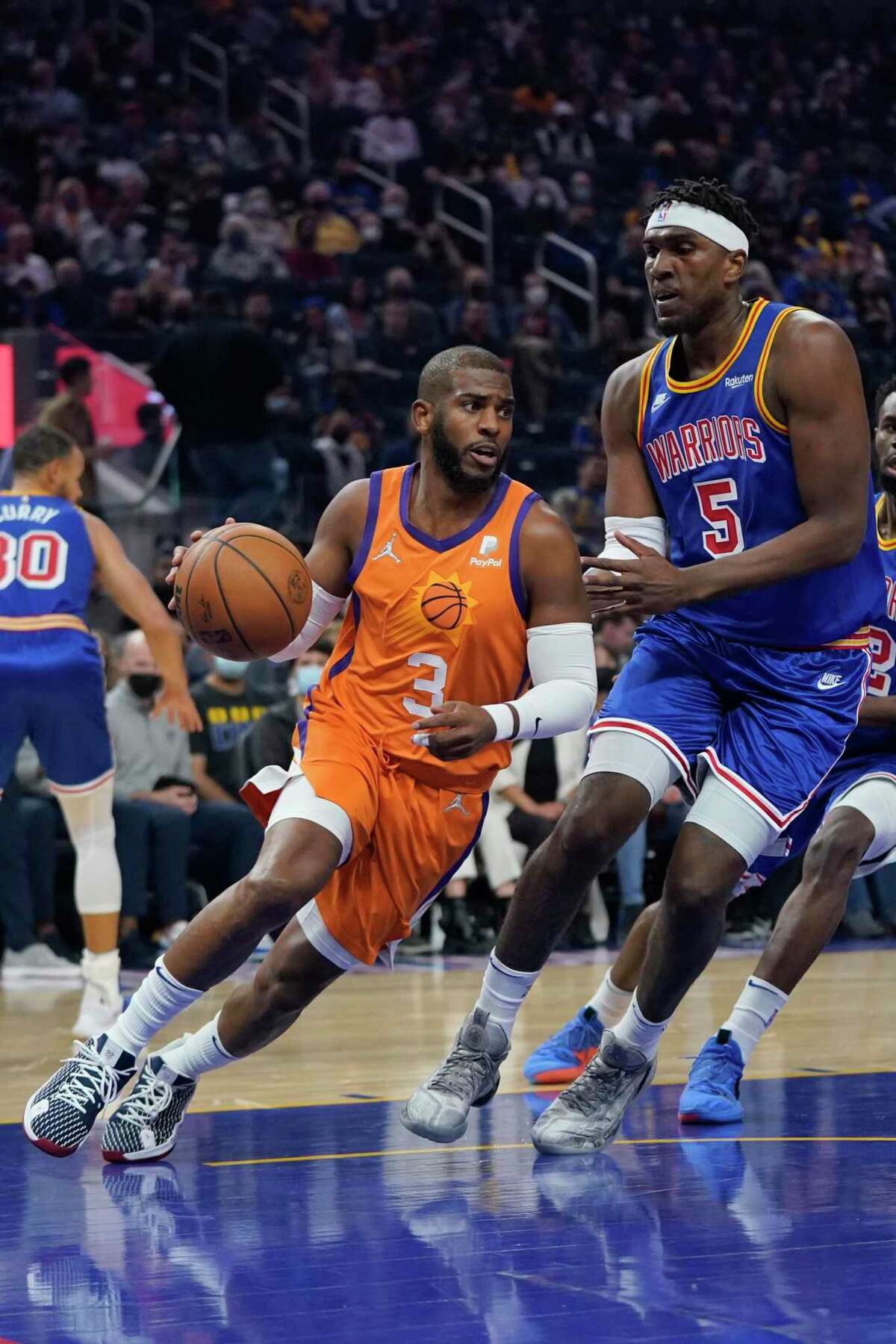 Phoenix Suns guard Chris Paul (3) drives to the basket against Golden State Warriors center Kevon Looney (5) during an NBA basketball game in San Francisco, Friday, Dec. 3, 2021. (AP Photo/Jeff Chiu)