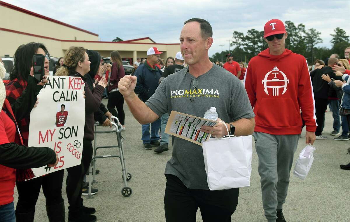 Tomball High School Head Football Coach Kevin Flanigan, center, brings up the rear as his Cougar team filed out of the THS fieldhouse during a sendoff for the Tomball Cougar varsity football team to Waco and McLane Stadium for the Cougar's Class 6A Division II semifinal matchup versus Denton Guyer on Saturday.