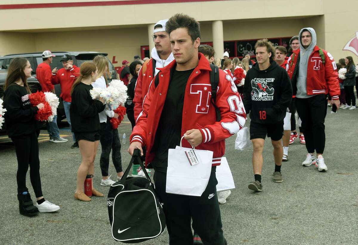 Tomball High School senior quarterback Cale Hellums and senior defensive tackle Jaden O'Bryan lead their Cougar teammates out of the THS fieldhouse during a sendoff for the Tomball Cougar varsity football team to Waco and McLane Stadium for the Cougar's Class 6A Division II semifinal matchup versus Denton Guyer on Saturday.