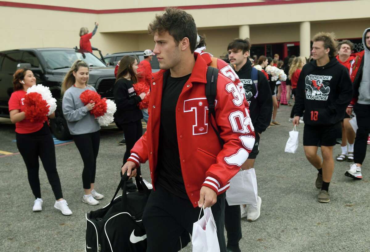 Tomball High School senior quarterback Cale Hellums leads his Cougar teammates out of the THS fieldhouse during a sendoff for the Tomball Cougar varsity football team to Waco and McLane Stadium for the Cougar's Class 6A Division II semifinal matchup versus Denton Guyer on Saturday.