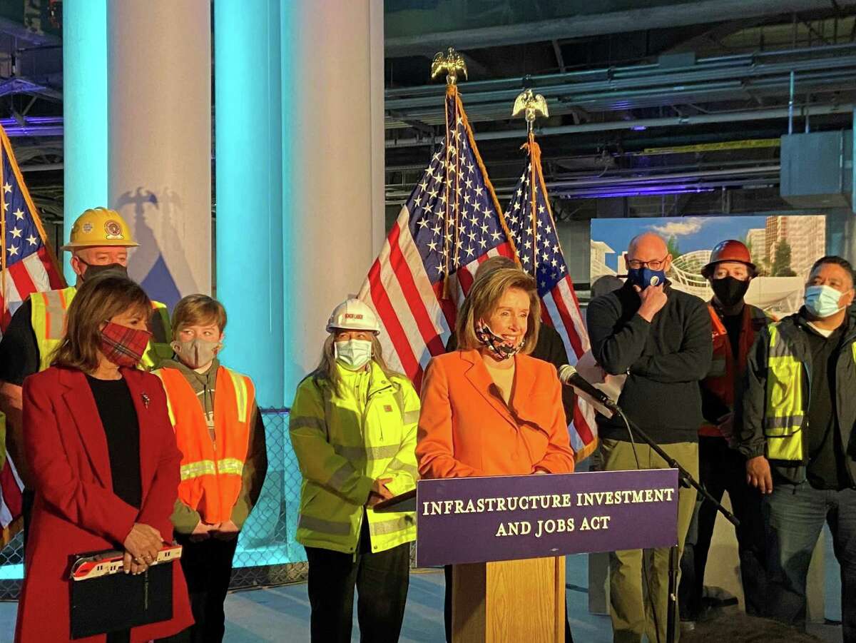 Speaker of the House Nancy Pelosi stands with Rep. Jackie Speier (left) and Bay Area transit leaders inside the Salesforce Transit Center to discuss how funds from the new bipartisan infrastructure act will affect the Bay Area.