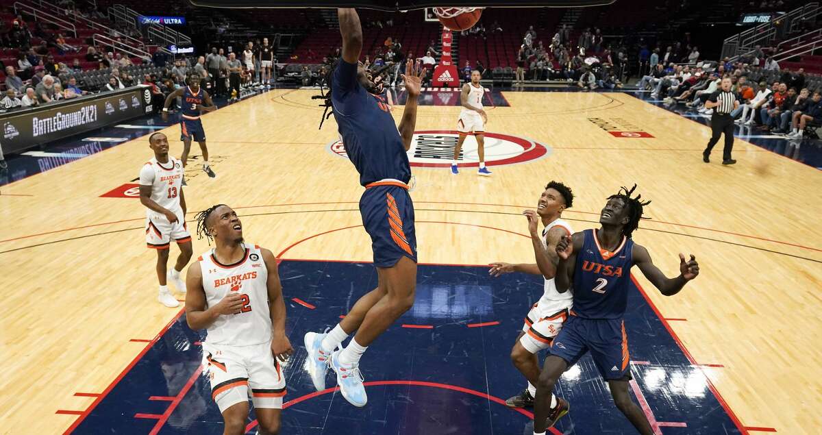 UTSA forward Cedrick Alley Jr., center, dunks during the second half of an NCAA college basketball game against Sam Houston State, Saturday, Dec. 11, 2021, in Houston.