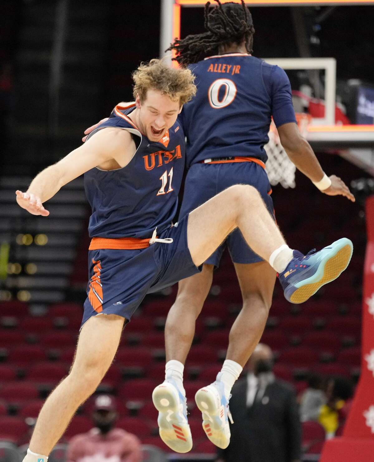 UTSA's Lachlan Bofinger (11) and Cedrick Alley Jr. celebrate the team's win over Sam Houston State in an NCAA college basketball game, Saturday, Dec. 11, 2021, in Houston.