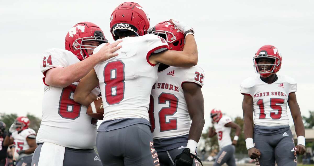 Dec. 11, 2021; Austin, Texas, USA; North Shore Mustangs Zach Chavanne (64) and David Amador (8) and Xavier Owens (32) and Kaleb Bailey (15) react after a touchdown against the Lake Travis Cavaliers in the second quarter in the Class 6A Division I state semifinal game at Reeves Stadium in Austin on Saturday. North Shore won 49-21. (Photo credit: Brendan Maloney / Chronicle)