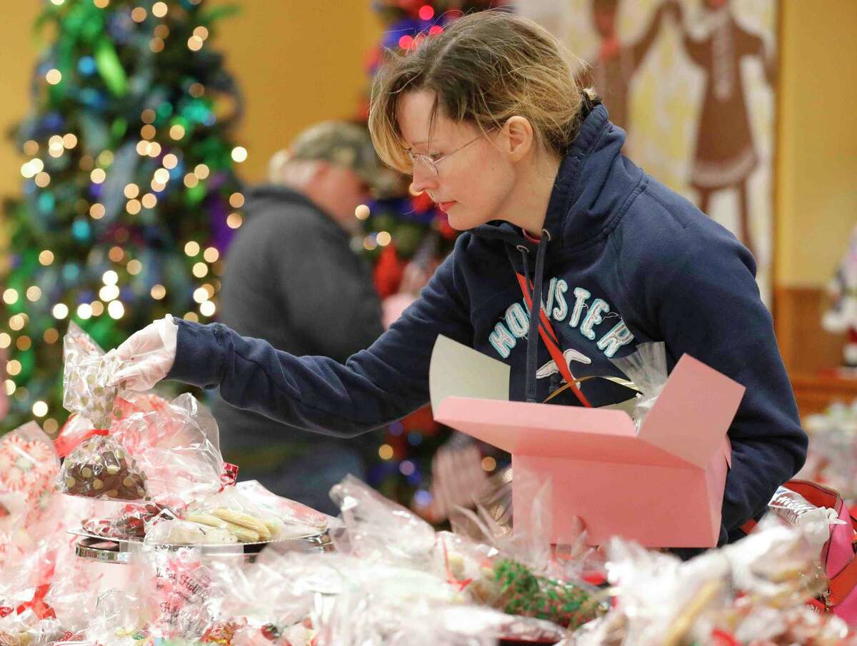 Jennie Cashmere picks up cookies during the annual cookie walk, Saturday, Dec. 11, 2021, in Montgomery.