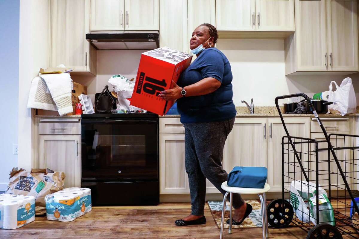 Delbra Taylor unloads kitchen supplies in her new apartment in Oakland. The Chronicle featured her in its Oakland Homeless Project, which focused on the stories of four native Oaklanders who became homeless.