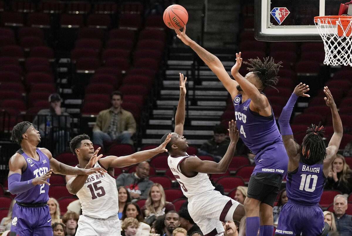 TCU center Eddie Lampkin (4) blocks the shot of Texas A&M guard Hassan Diarra (5) during the second half of an NCAA college basketball game, Saturday, Dec. 11, 2021, in Houston.